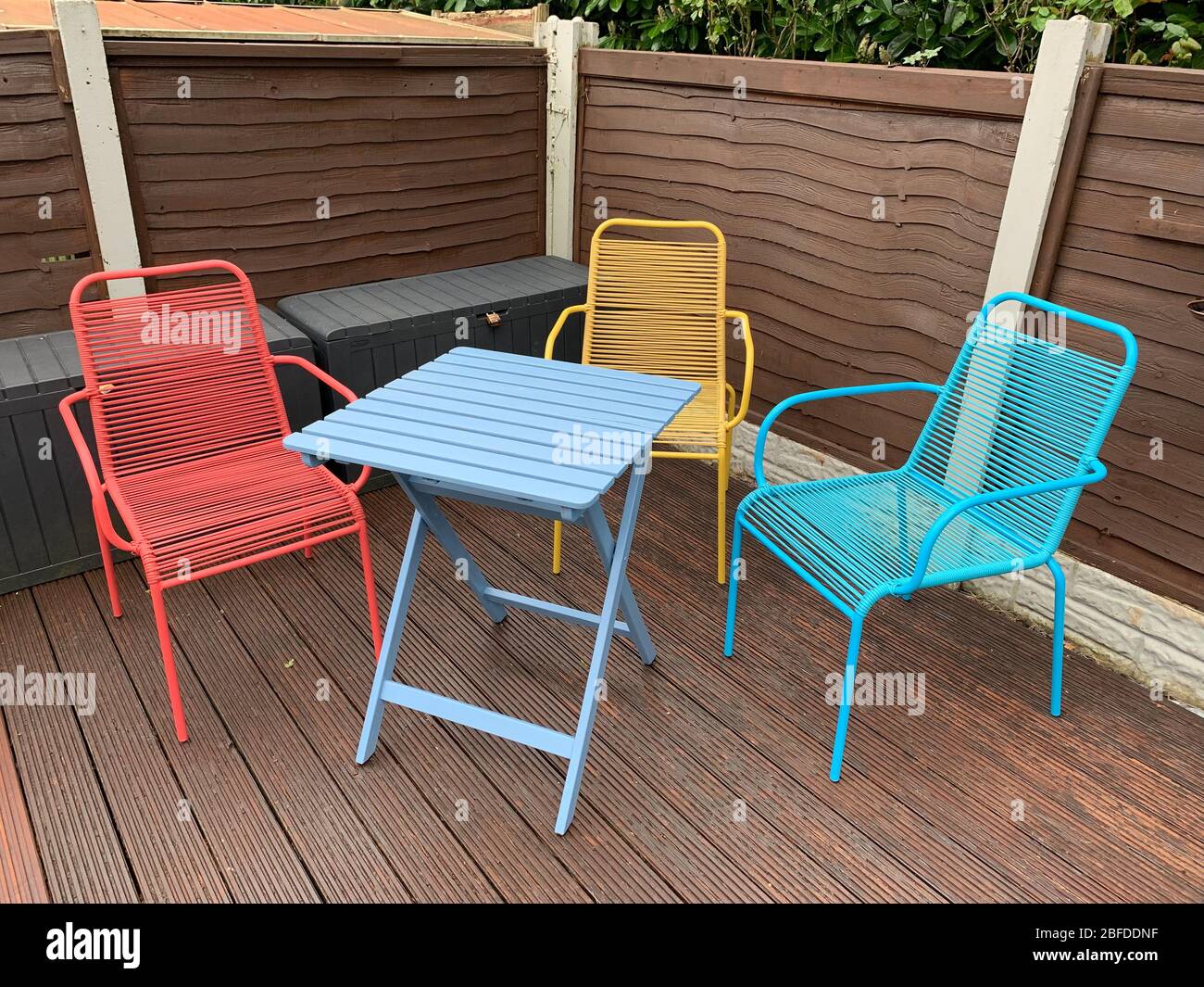 A Bright Coloured Outdoor Bistro Garden Table And Chairs On Some
