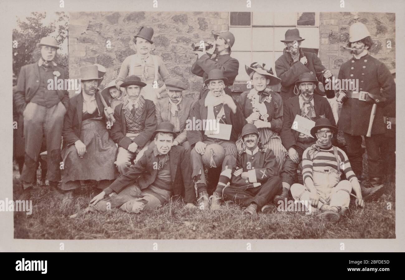 Vintage Early 20th Century Photographic Postcard Showing a Group of Men Wearing Fancy Dress Stock Photo