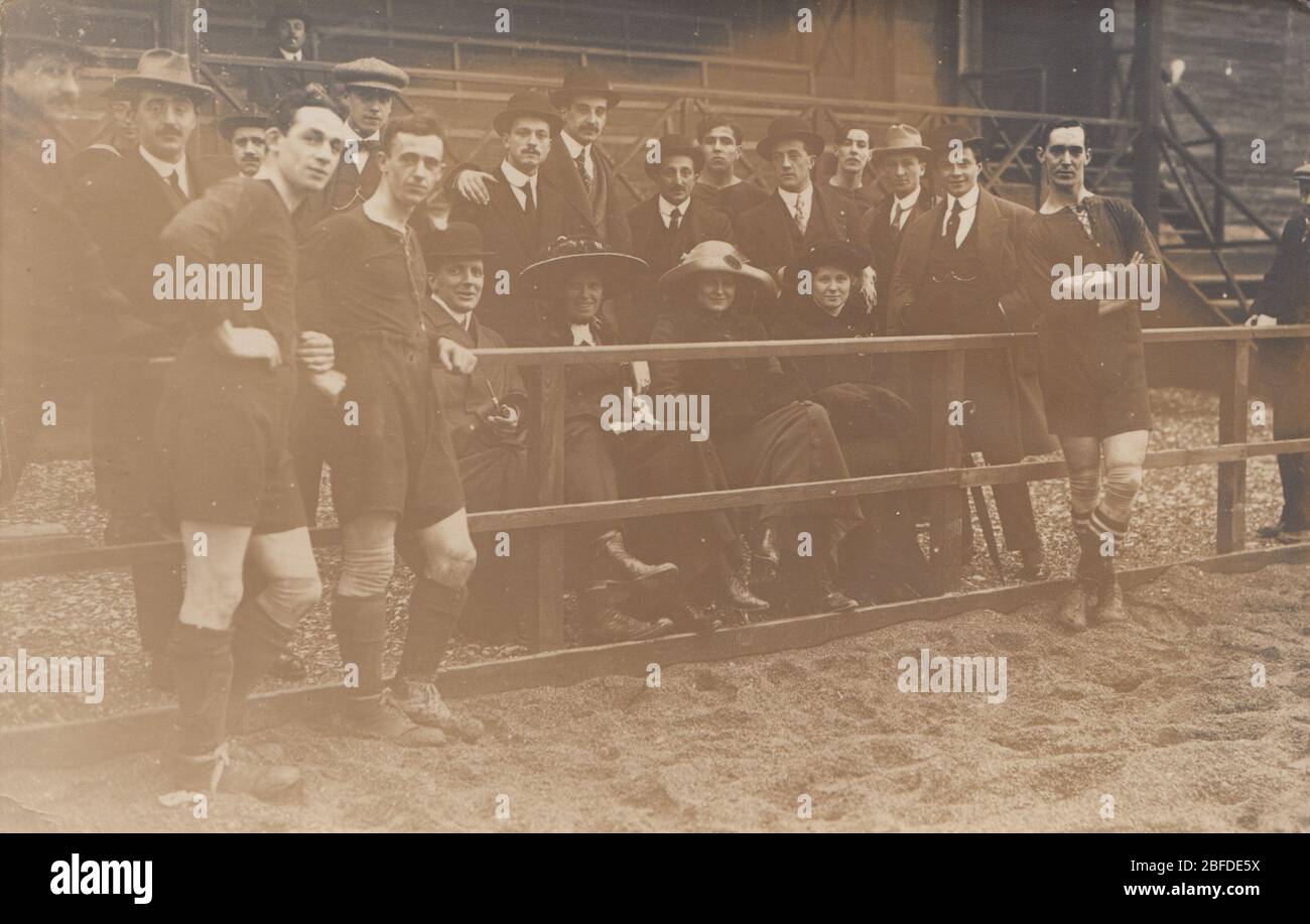 Vintage Early 20th Century Photographic Postcard Showing Football Players and a Group of Spectators Inside a Sports Stadium. Stock Photo