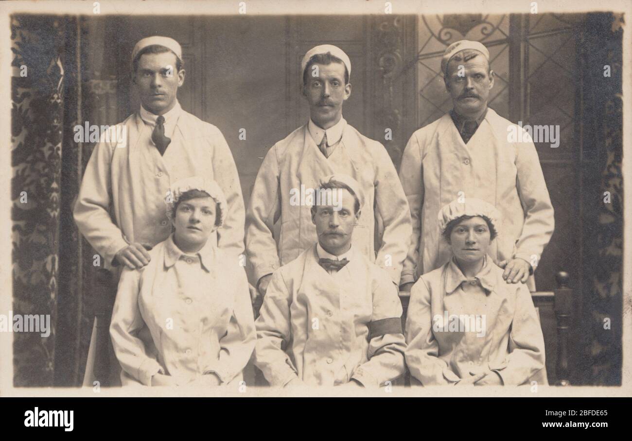 Vintage Photographic Postcard Showing a Male and Female Group of Munition Workers Stock Photo