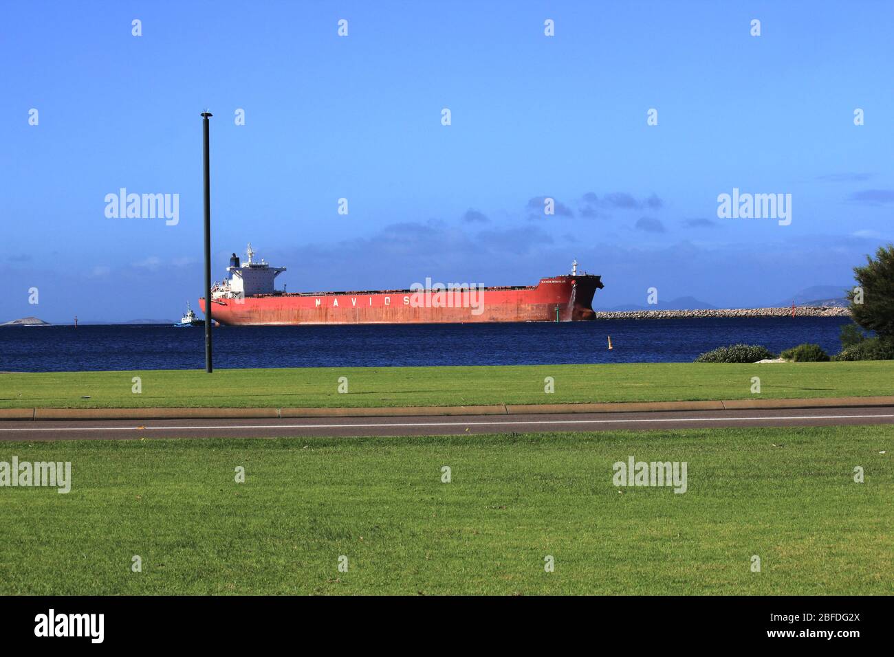 Big red cargo ship on the ocean at Esperance, Western Australia Stock
