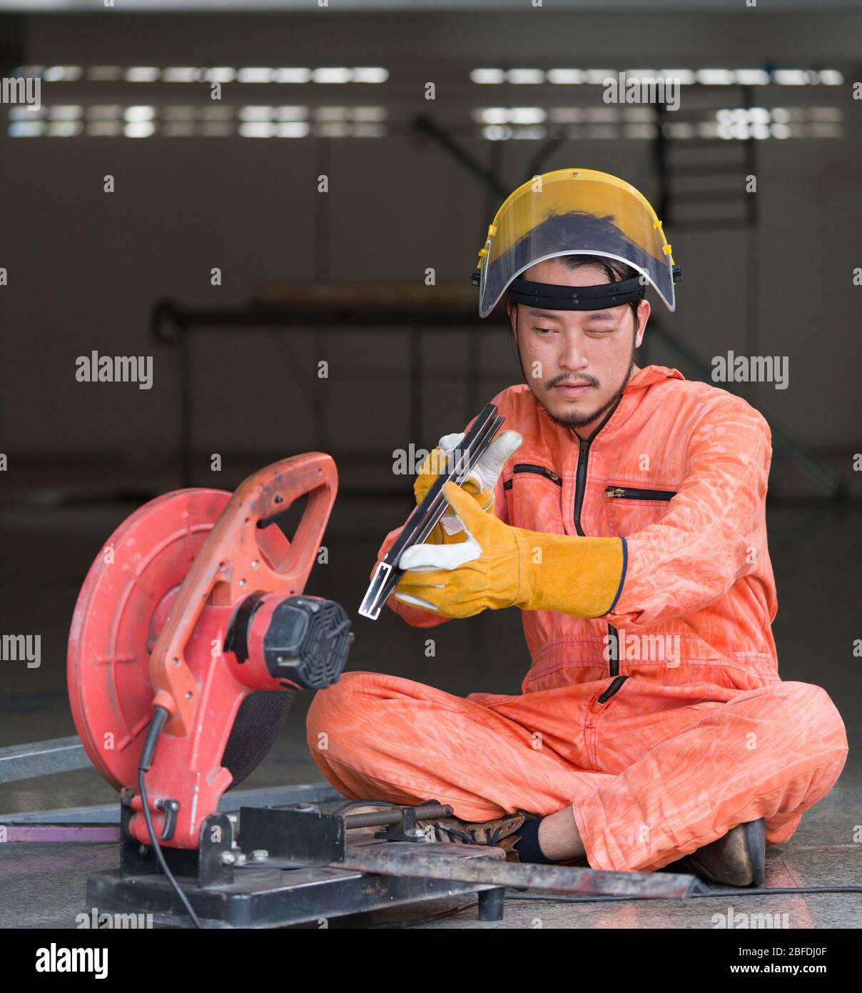 Industrial workers inspect cut steel to the size required by customers. For the real estate project received. Metal grinding on steel spare part in wo Stock Photo