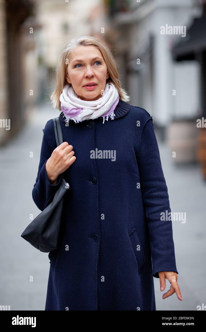 Happy pretty mature woman walks hi-res stock photography and images - Alamy