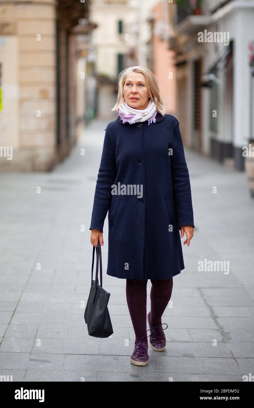 Happy pretty mature woman walks hi-res stock photography and images - Alamy