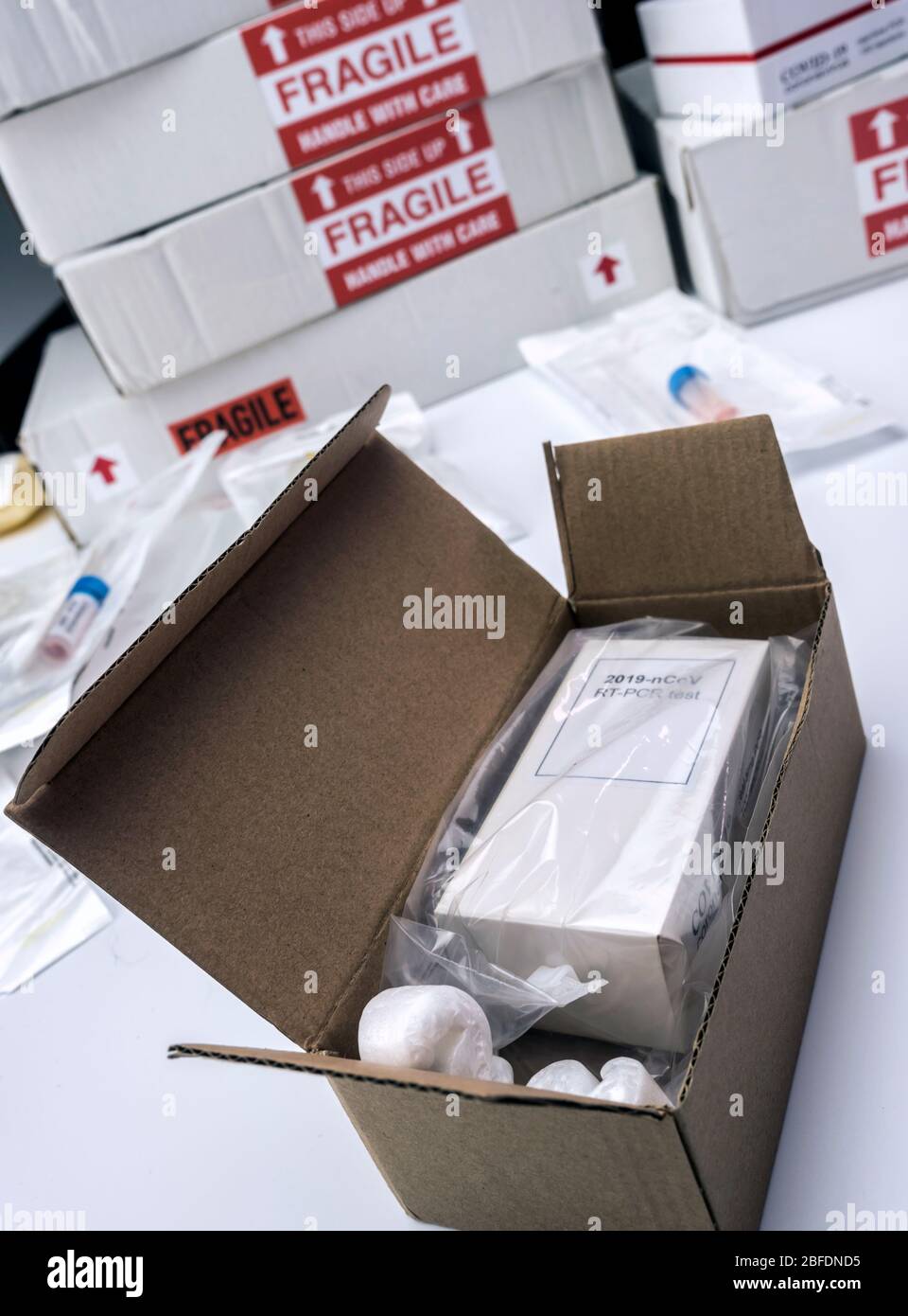 Boxes with Covid-19 PCR kit in hospital warehouse, conceptual image Stock Photo