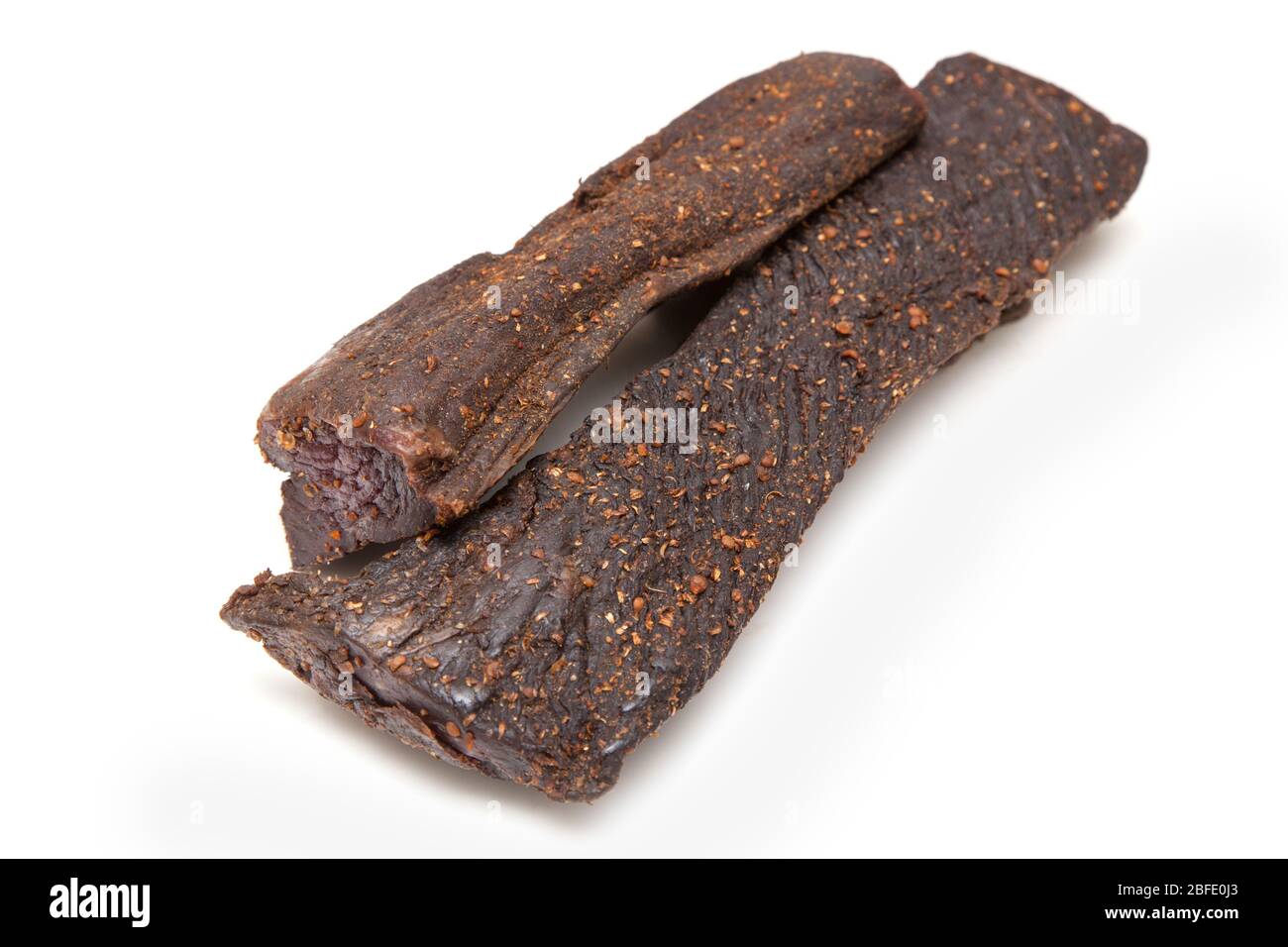 Beef Biltong, South African Beef Jerky isolated on a white studio background. Stock Photo