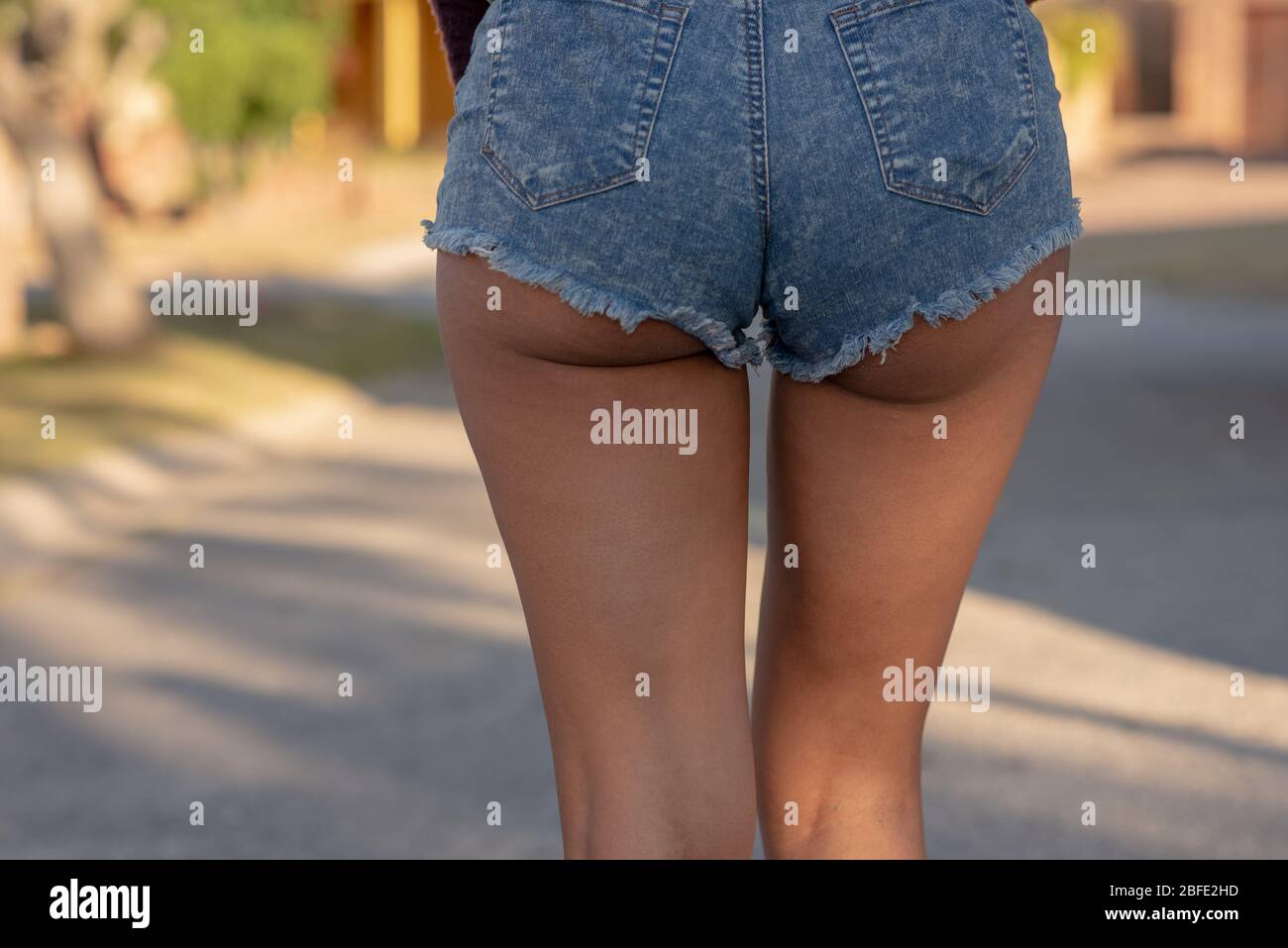 Rear view of young woman with tight jeans on Stock Photo