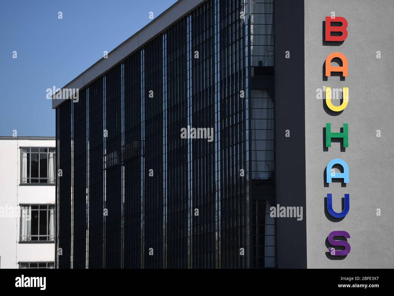 Gøre klart Station dør 18 April 2020, Saxony-Anhalt, Dessau-Roßlau: The striking Bauhaus lettering  on the façade of the Bauhaus building in Dessau-Roßlau glows in bright  colours. The Bauhaus is considered a magnet for tourists in the