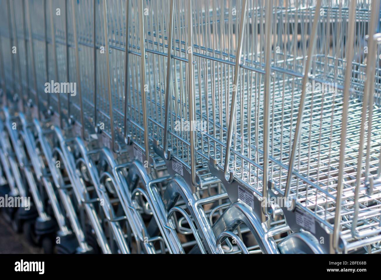 A lot of shopping trolleys. Modern supermarket shopping carts in a row. Stock Photo