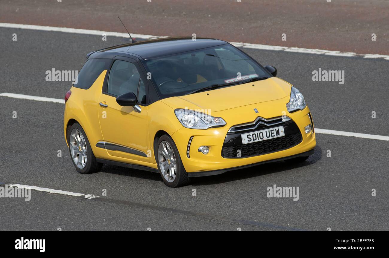 2010 yellow Citroën DS3 Dsport; Vehicular traffic moving vehicles, driving vehicle on UK roads, motors, motoring on the M6 motorway highway Stock Photo