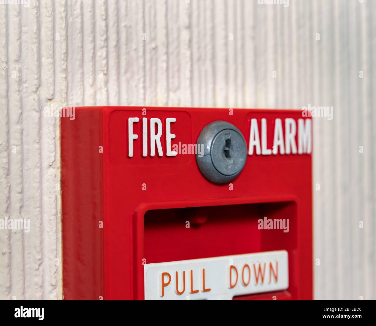 Fire alarm system pull station. Concept of fire safety, fire drill, evacuation plan Stock Photo
