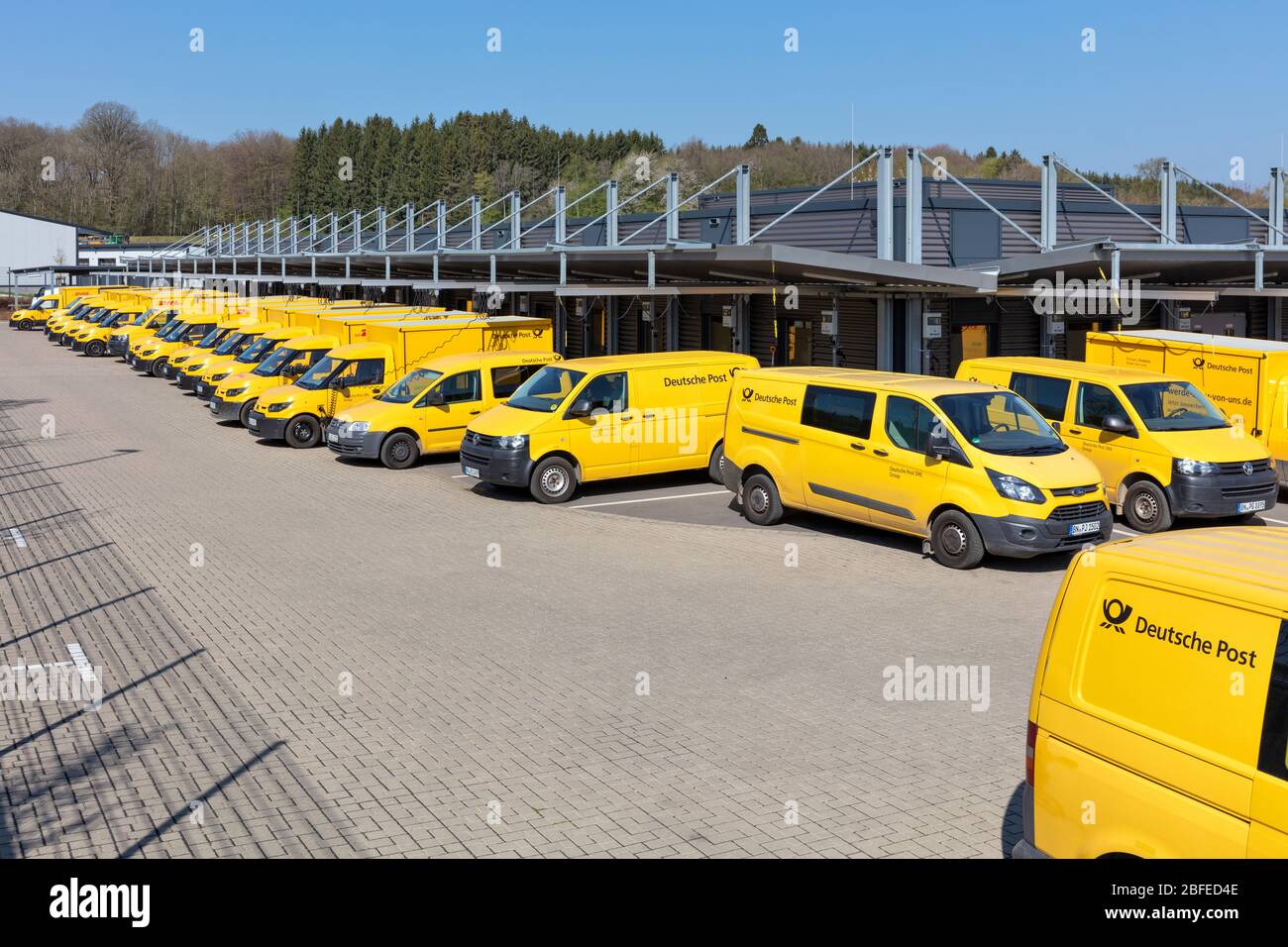 Deutsche Post delivery vans at depot. Deutsche Post is a brand of Deutsche Post AG used for its domestic mail services in Germany. Stock Photo