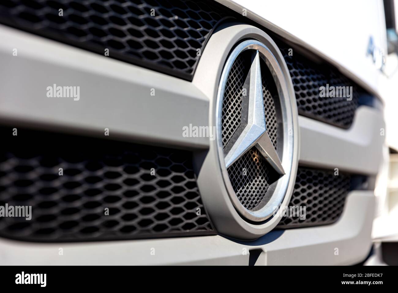 Mercedes-Benz logo at the grill of an Atego truck. Mercedes-Benz is a German global automobile marque and a division of Daimler AG. Stock Photo