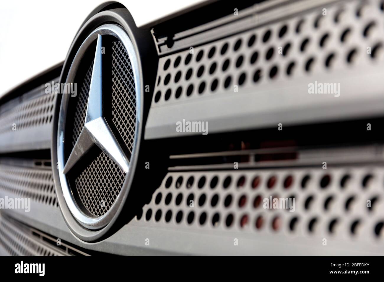 Mercedes-Benz logo at the grill of an Atego truck. Mercedes-Benz is a German global automobile marque and a division of Daimler AG. Stock Photo