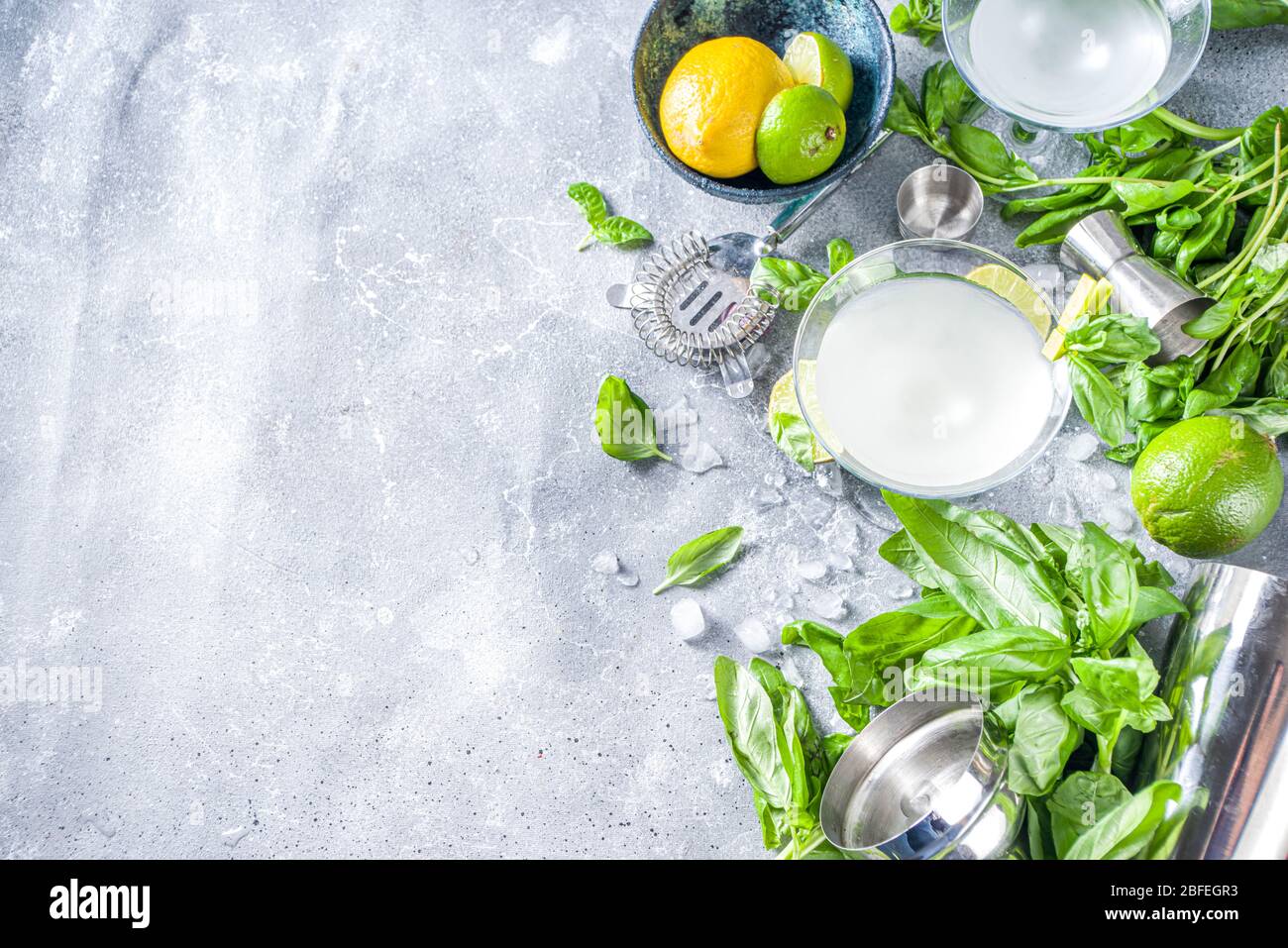 Basil vodka gimlet martini cocktail. Strong alcohol drink with fresh