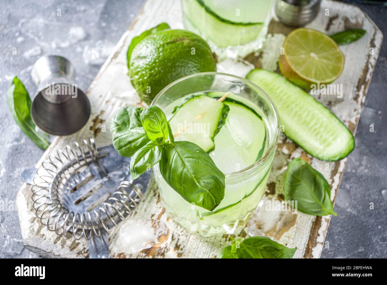 Cucumber basil smash gin and vodka alcohol cocktail. Infused summer
