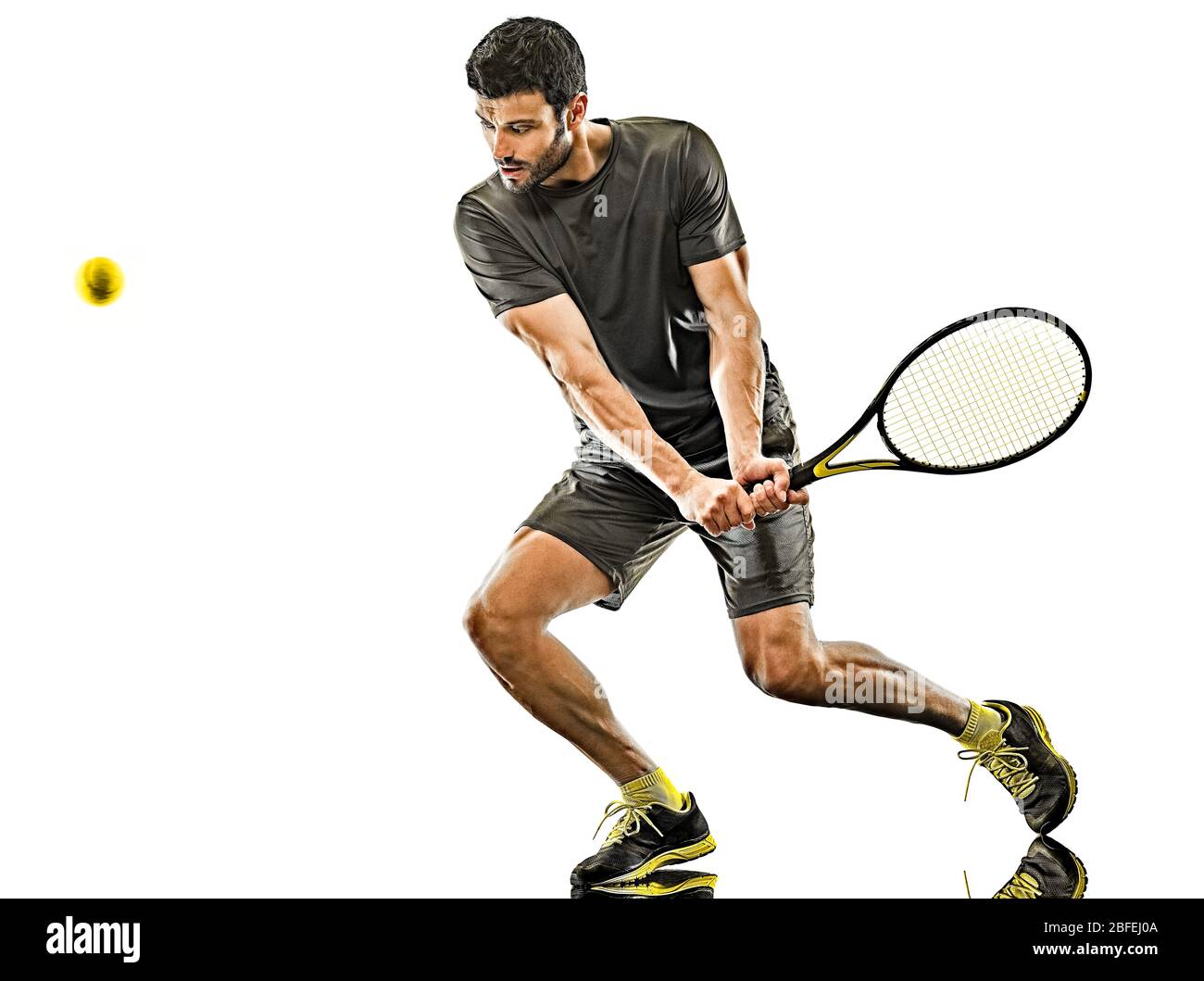 one caucasian mature tennis player man backhand full length silhouette in studio isolated on white background Stock Photo