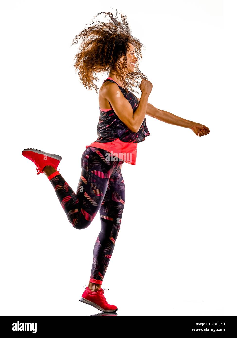 one african mixed race mature woman cardio dancer dancing fitness exercises in studio isolated on white background Stock Photo
