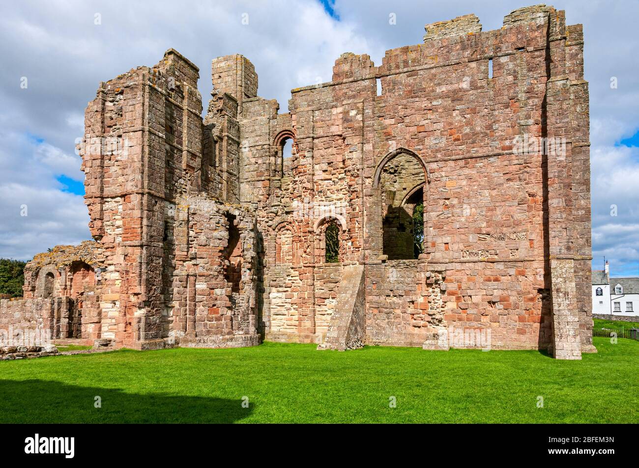 Bright sunlight is reflected from the walls of the eastern end of the church of Lindisfarne Priory enclosing the transept, chancel and presbytery Stock Photo