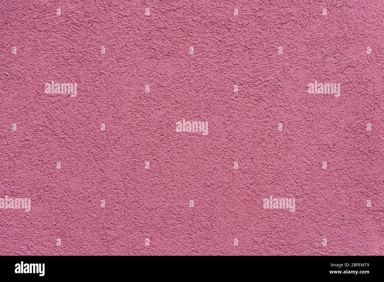 Texture of pink or purple painted and plastered building wall Stock Photo