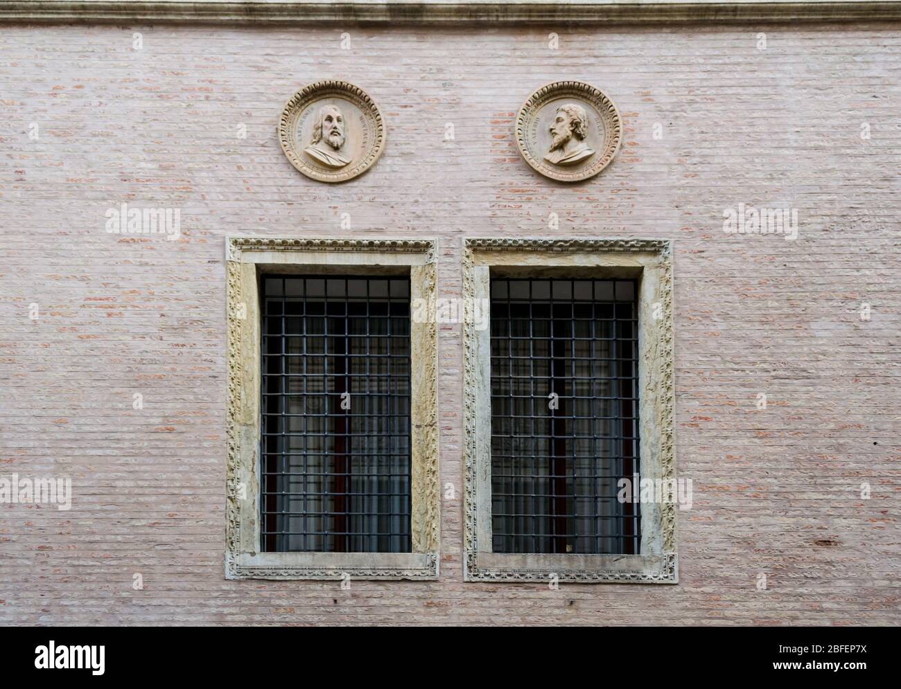 Vicenza, Italy. A nice couple of window in a brick wall of one the the many beautiful palaces of this interesting town Stock Photo