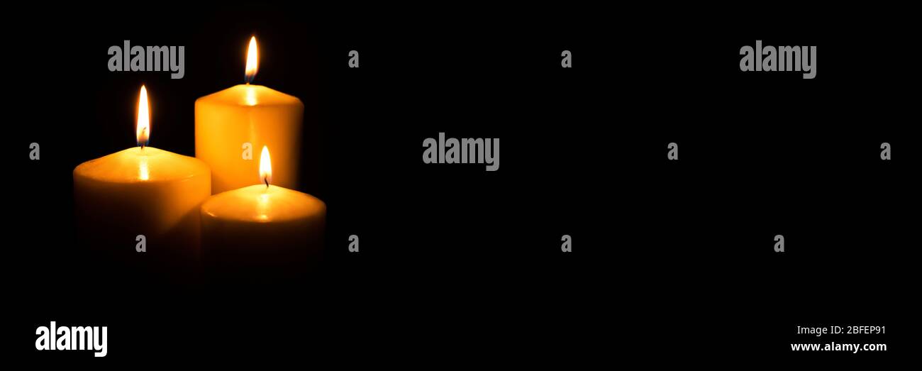 Flame candles isolated on black background Stock Photo - Alamy