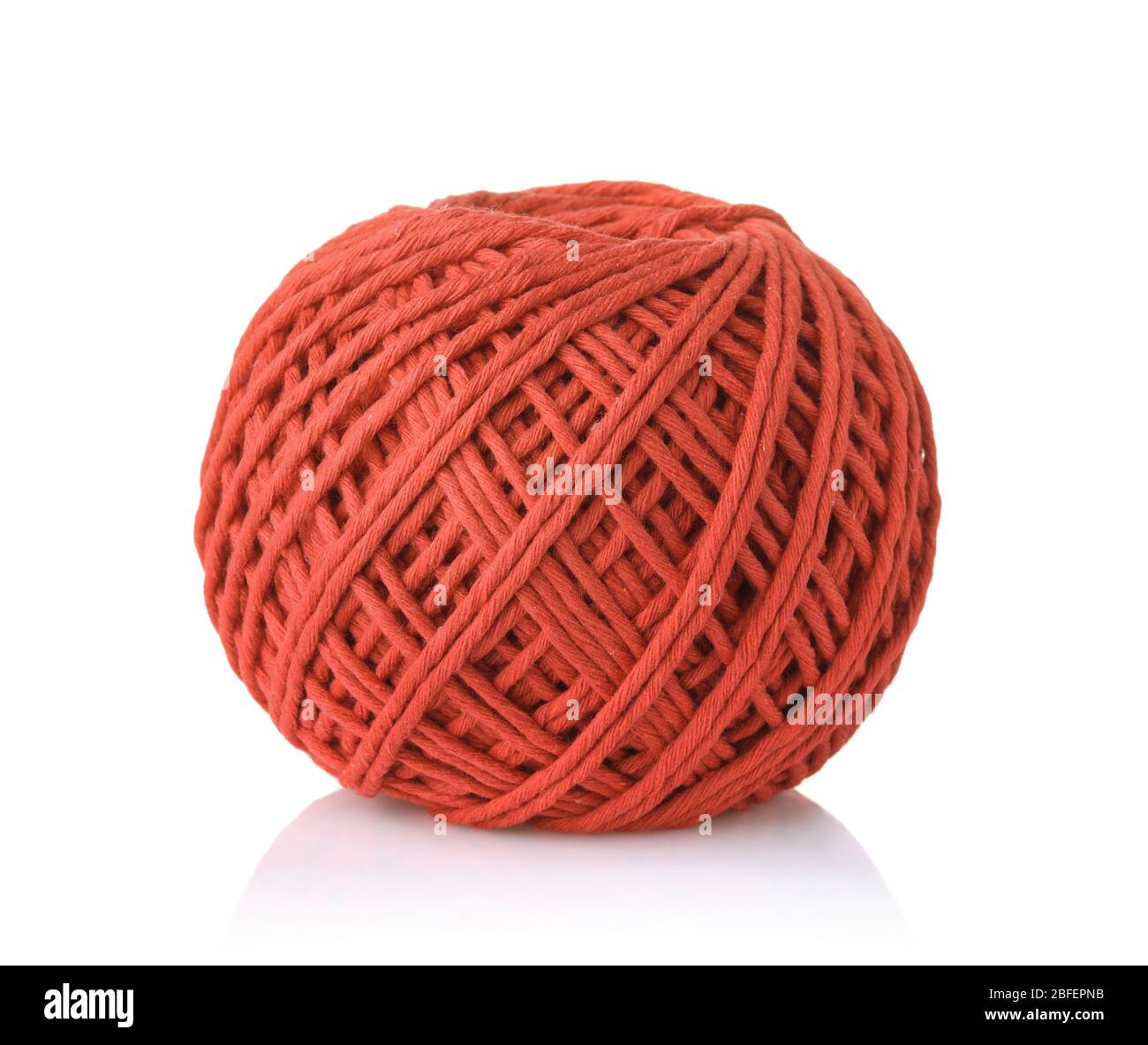 Clew of red cotton thread isolated on white Stock Photo