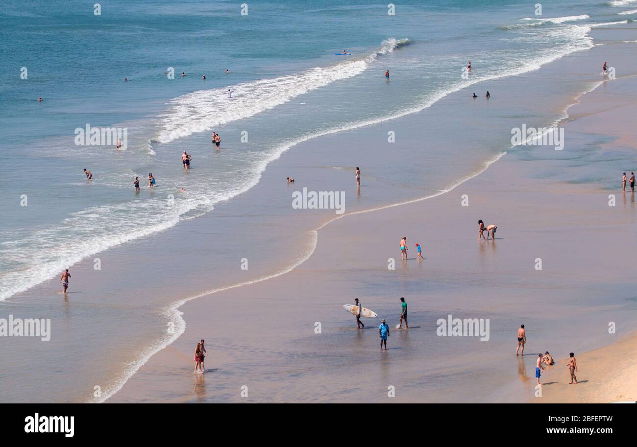 domestic and forign tourists enjoying in the beaches of papanasam,varkala,thiruvananthapuram,kerala,india,pradeep subramanian,beach tourism,papanasam Stock Photo