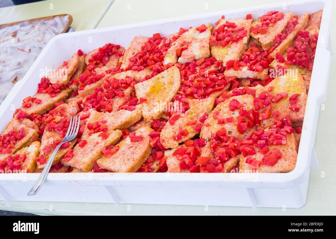 good and genuine slices of bread topped with ripe and fresh tomatoes, oil and salt. Stock Photo