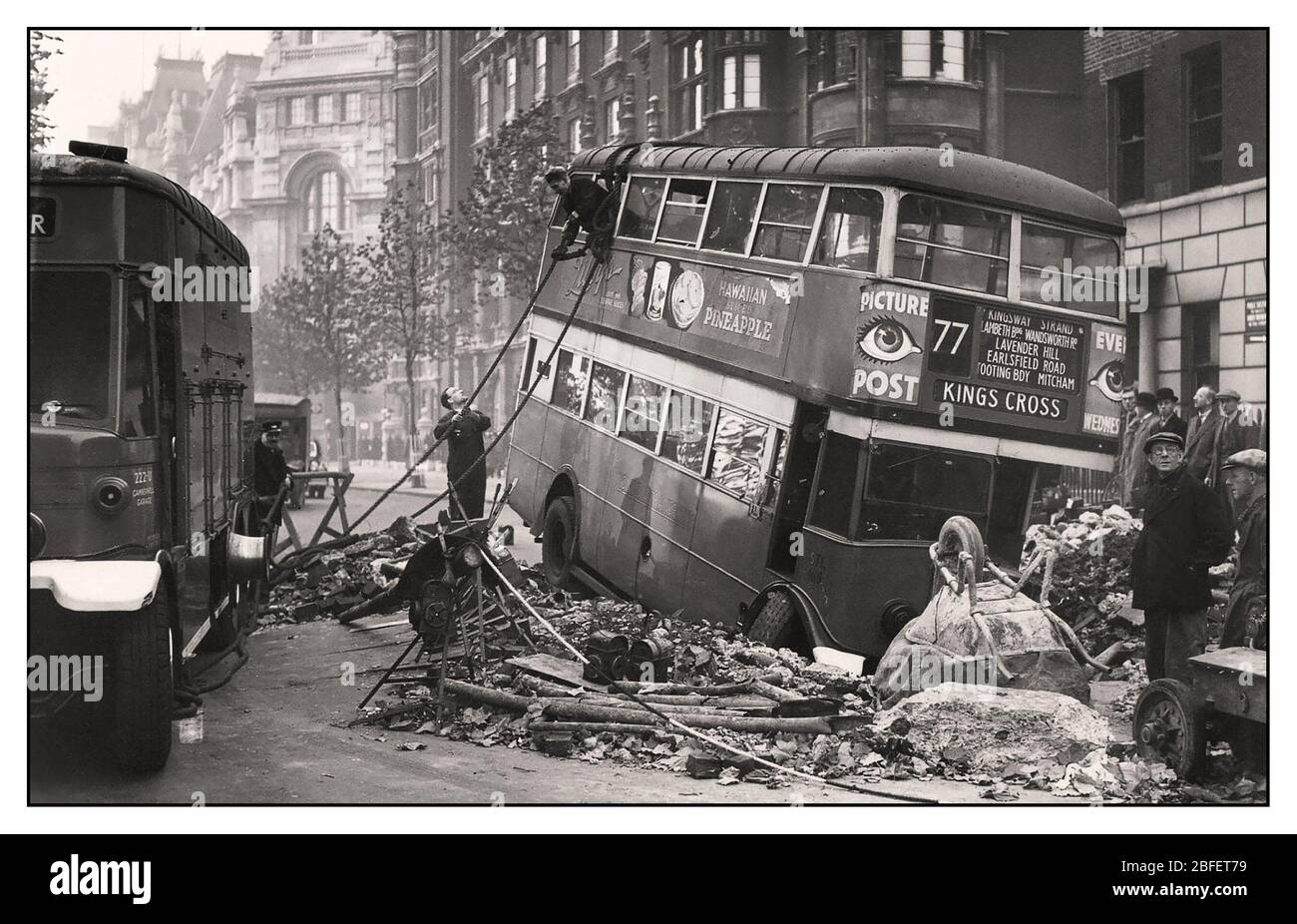 London Blitz 1940s WW2 Archive image of London Bus en-route to Kings Cross in bomb crater caused by terror bombing by the Nazi Germany Luftwaffe airforce Stock Photo