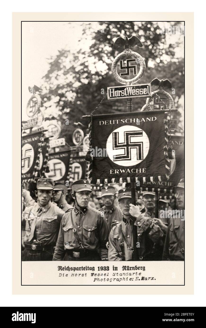 Archive vintage 1930's Nazi Propaganda image with Sturmabteilung Troops (Storm Detachment) and banner flags 'Reichsparteitag Nürnberg 1933' , 'Freedom and Bread Nazi Party Rally Nuremberg 1-3 September 1933', with flag standard 'Deutschland Erwache' 'GERMANY AWAKES' 'Freiheit und Brot Reichsparteitag Nürnberg 1.-3 September 1933', Nazi Germany 1933, 'Freiheit und Brot Reichsparteitag Nürnberg 1-3 September Germany Stock Photo