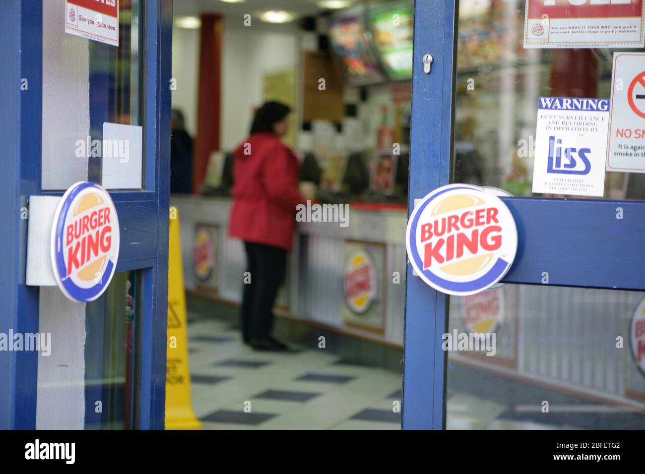 A female Burger King customer placing her order Stock Photo Alamy