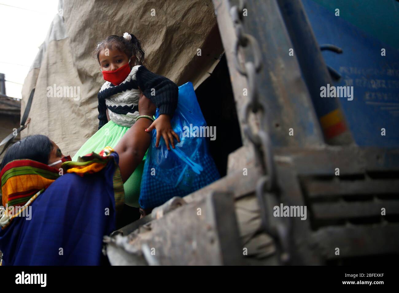 Kathmandu Nepal. 18th Apr 2020. Daily wage workers and their families get on a vehicle to return to their village on the 26th day of a government imposed lockdown amid concerns over