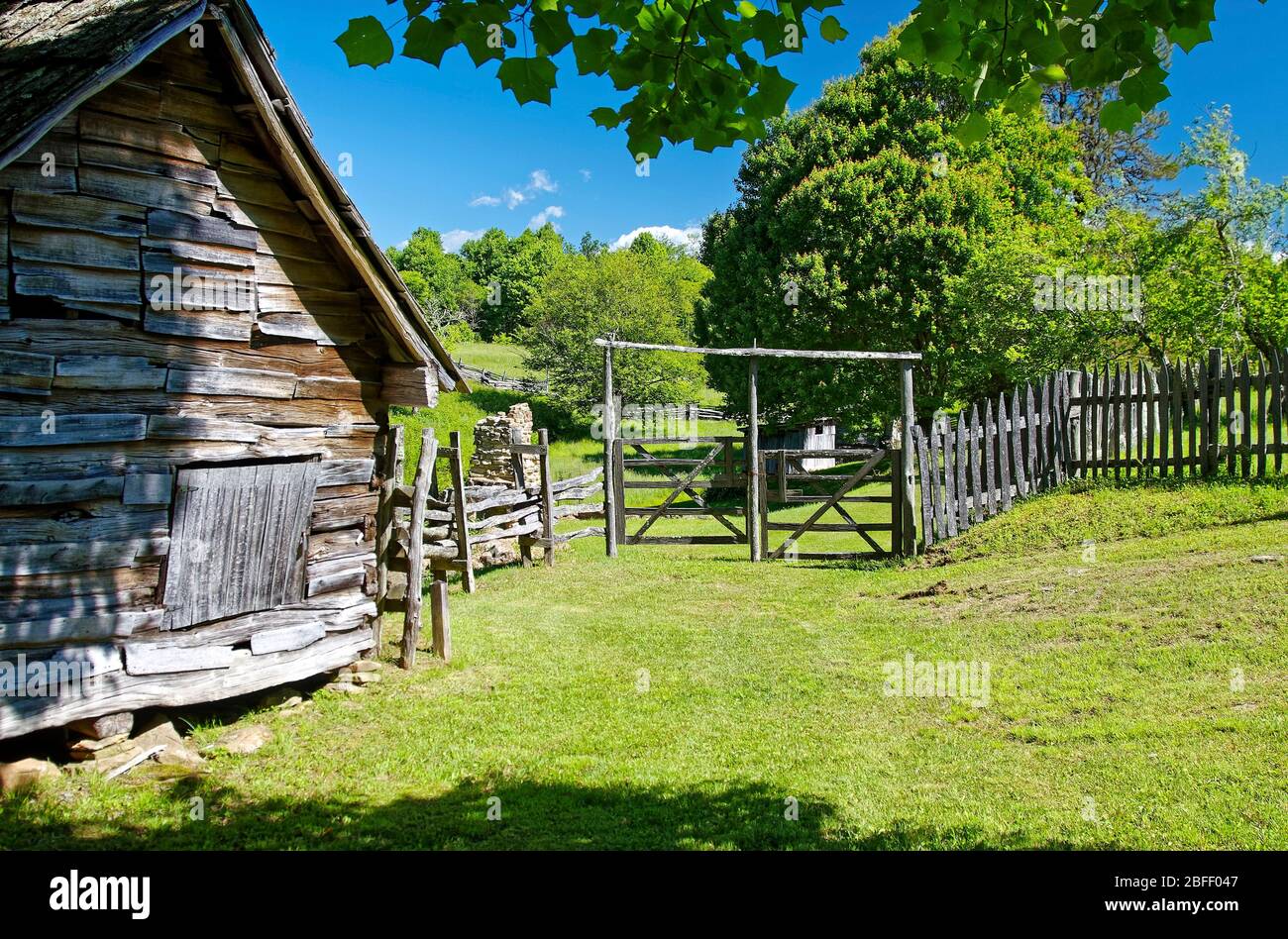 rural scene, wood gates, old log cabin, hand-hewn, wood picket fence, trees, grass, Hensley Settlement, 1903, Brush Mountain, Cumberland Gap National Stock Photo