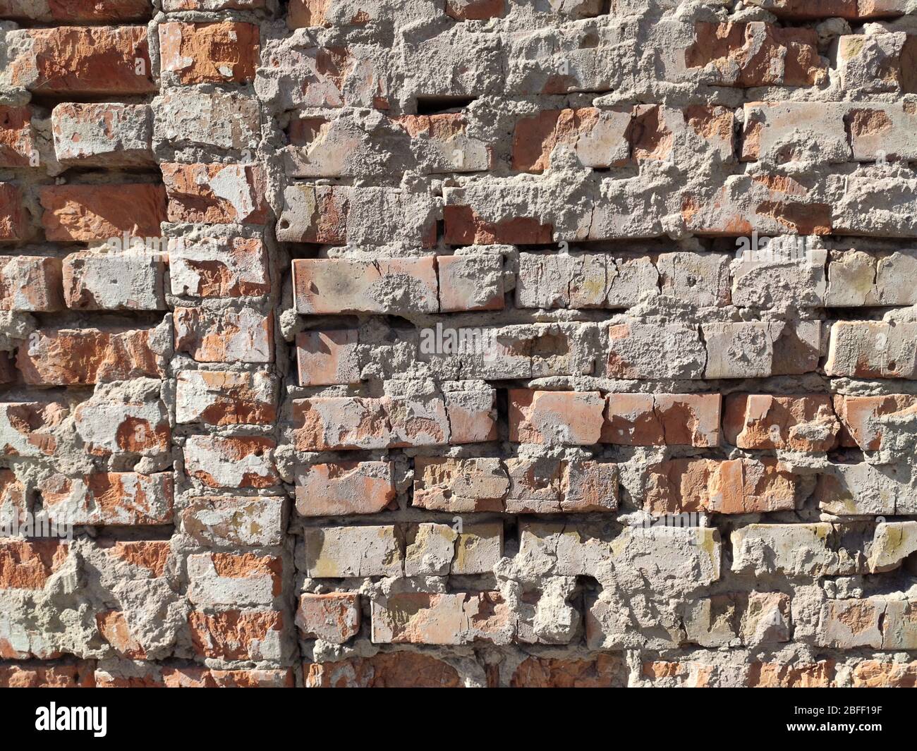 Old brick yellow background texture. Porous brick wall in temple at sunset Stock Photo