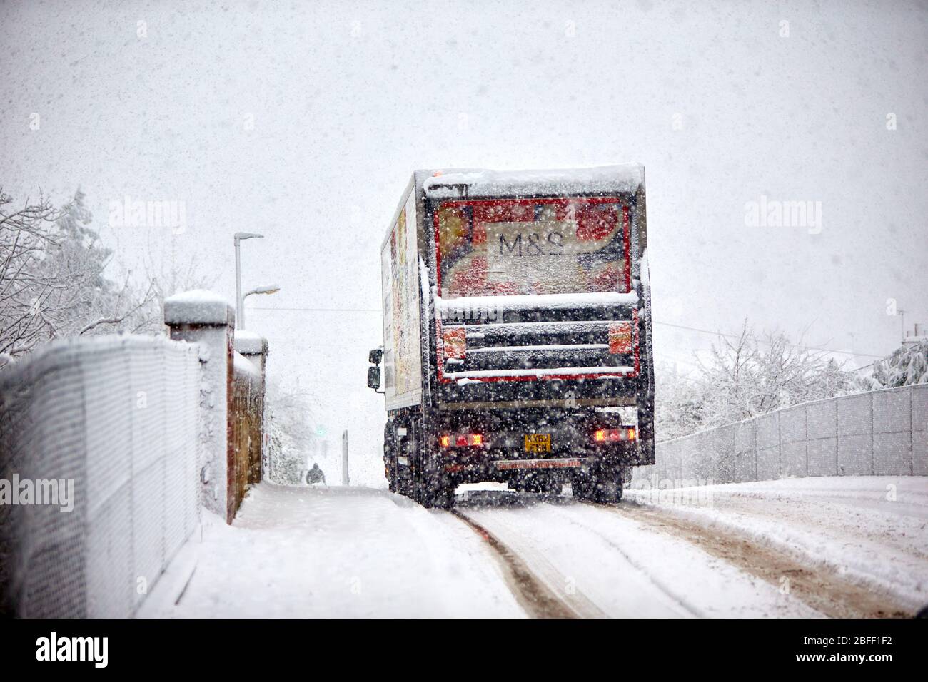 A M&S lorry drives down a snow covered street near Aylesbury. Heavy snow is causing widespread transport problems. Stock Photo