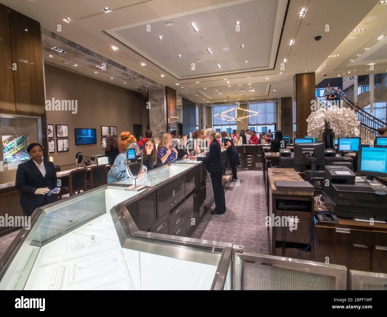 Shoppers choose jewelry at Tiffany store in Manhattan Stock Photo Alamy