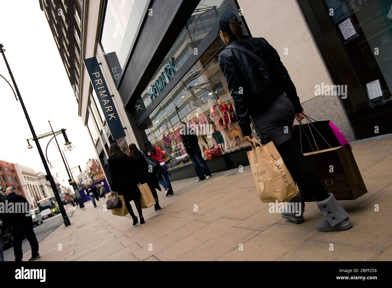 A Primark customer walking down Oxford Street after a day shopping at