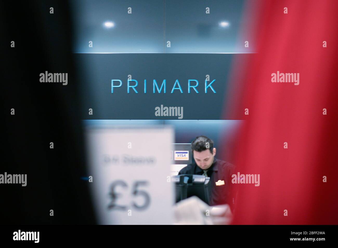 A Primark employee working at a till point Stock Photo Alamy