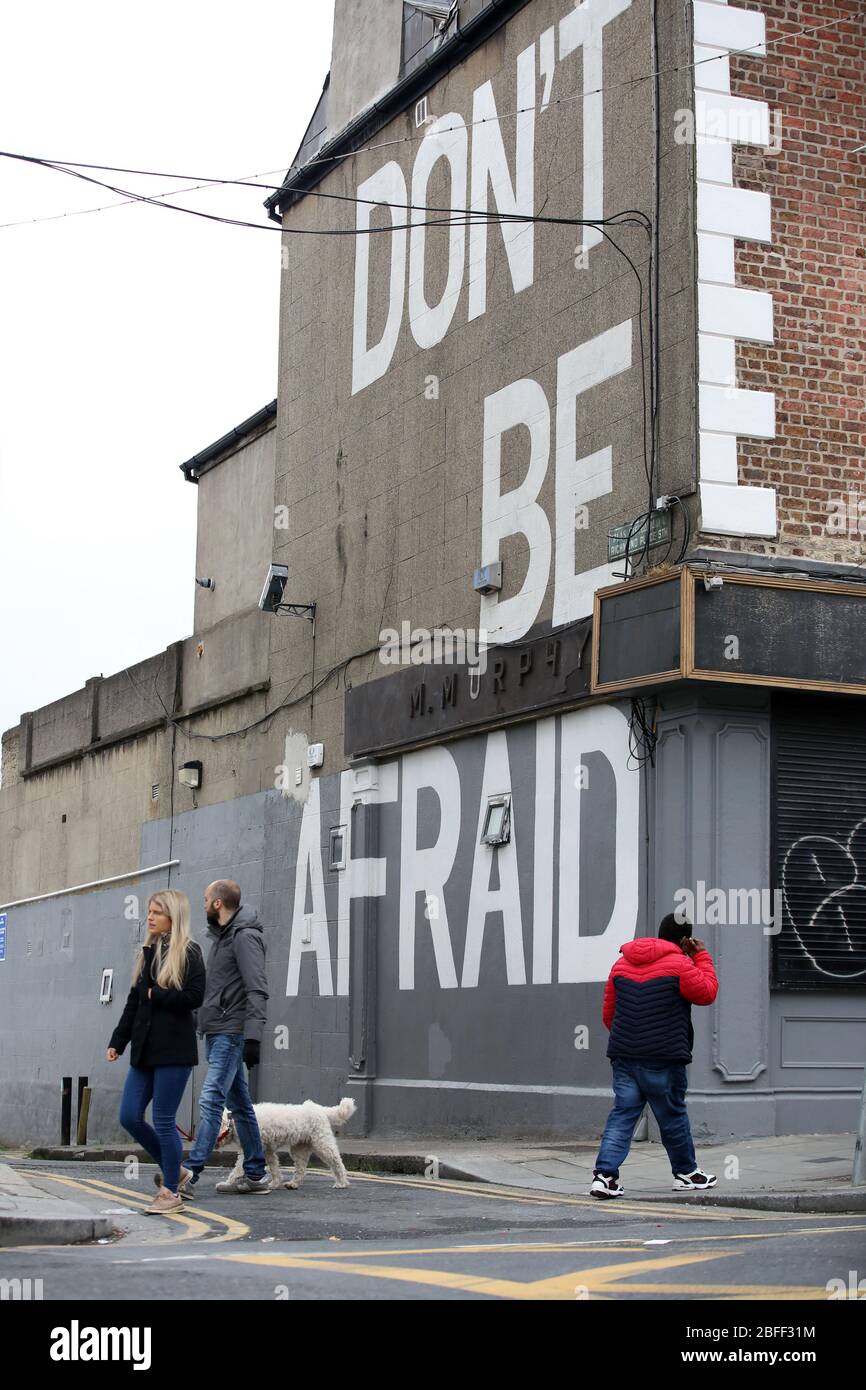 Dublin, Ireland. 18/April/2020. Covid-19 Pandemic (Coronavirus), Ireland. Day 22 Lockdown. Members of the public walk past a mural just off Richmond Street South in Dublin, with the words Don’t Be Afraid on the side of a building, as Ireland enters its third week of LockdownPhoto: Sam Boal/Rollingnews.ie Stock Photo