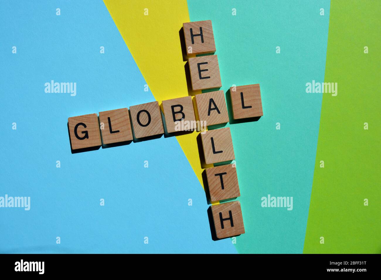 Global, Health, words in 3d wooden alphabet letters in a crossword isolated on colourful background Stock Photo