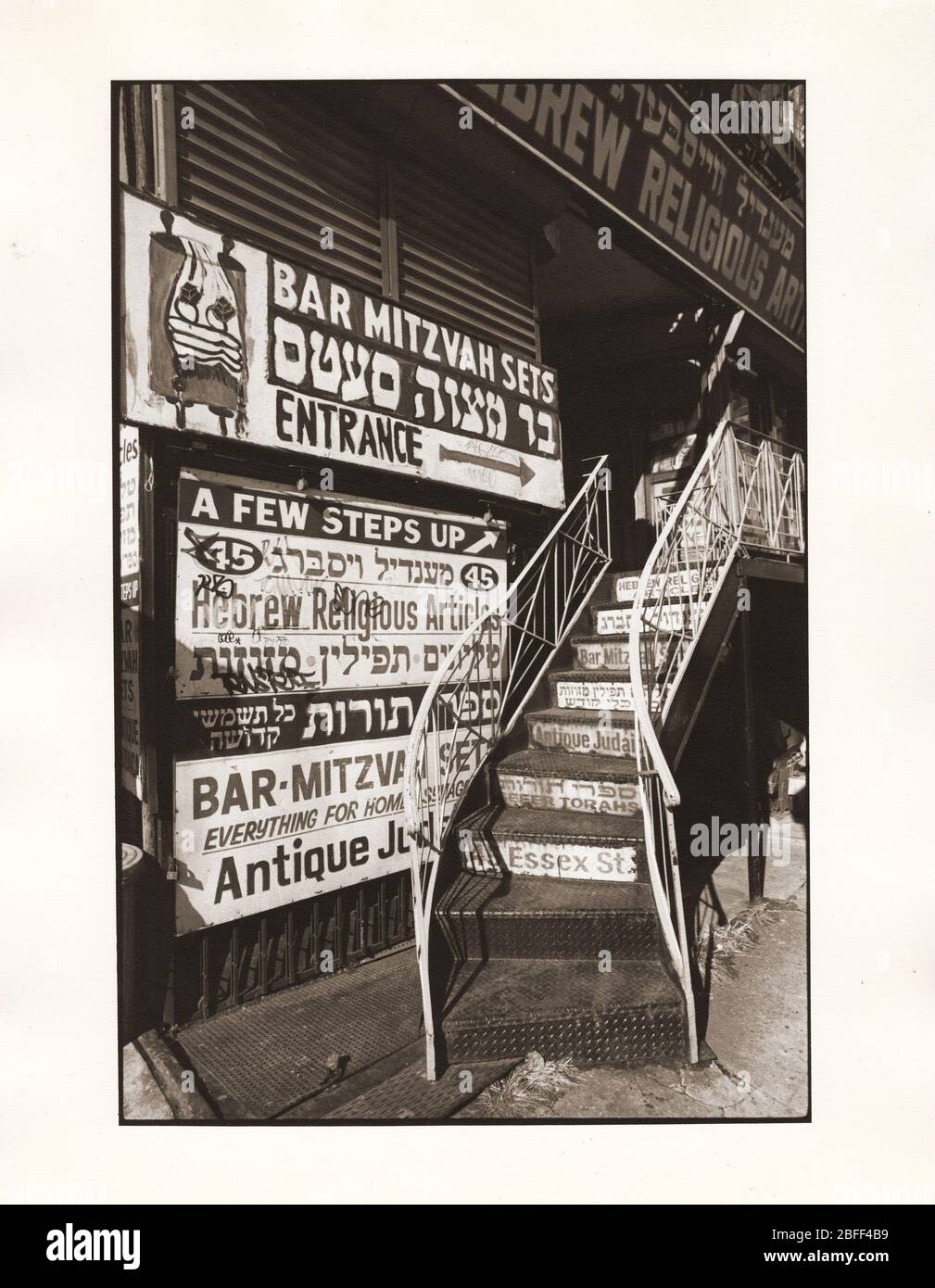 The stairway & signs for Mendel Weissberg's Hebrew Religious Articles store at 45 Essex St. on the Lower East Side of Manhattan, New York City. c Stock Photo