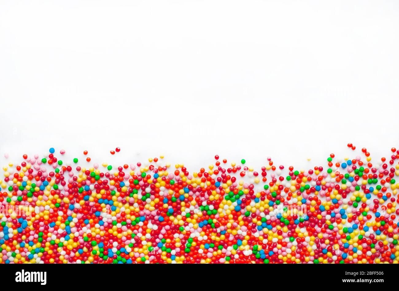 Colored sugar balls on a white background. Used to decorate baking and sweets Stock Photo Alamy