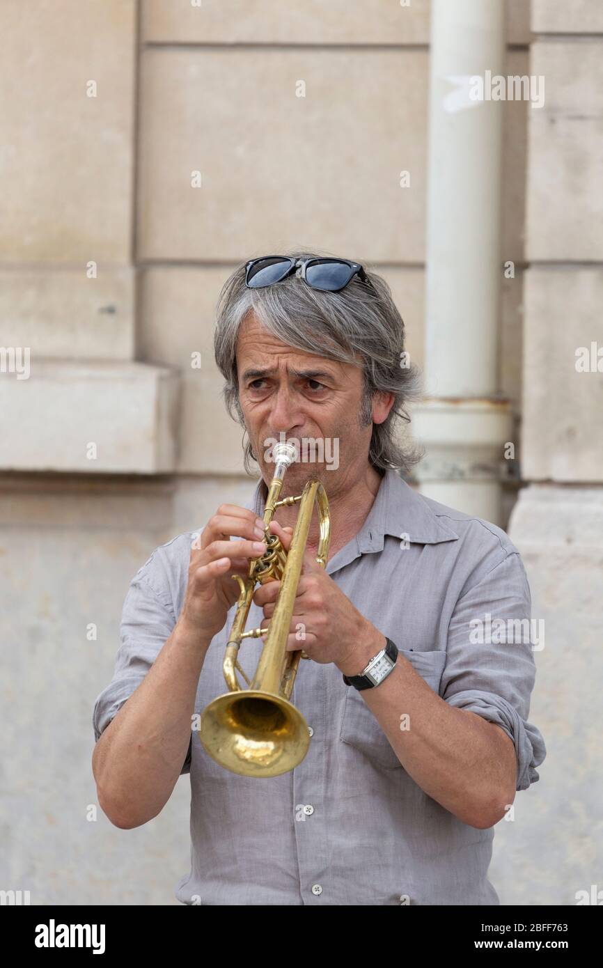 A man busking on the trumpet in Paris Stock Photo