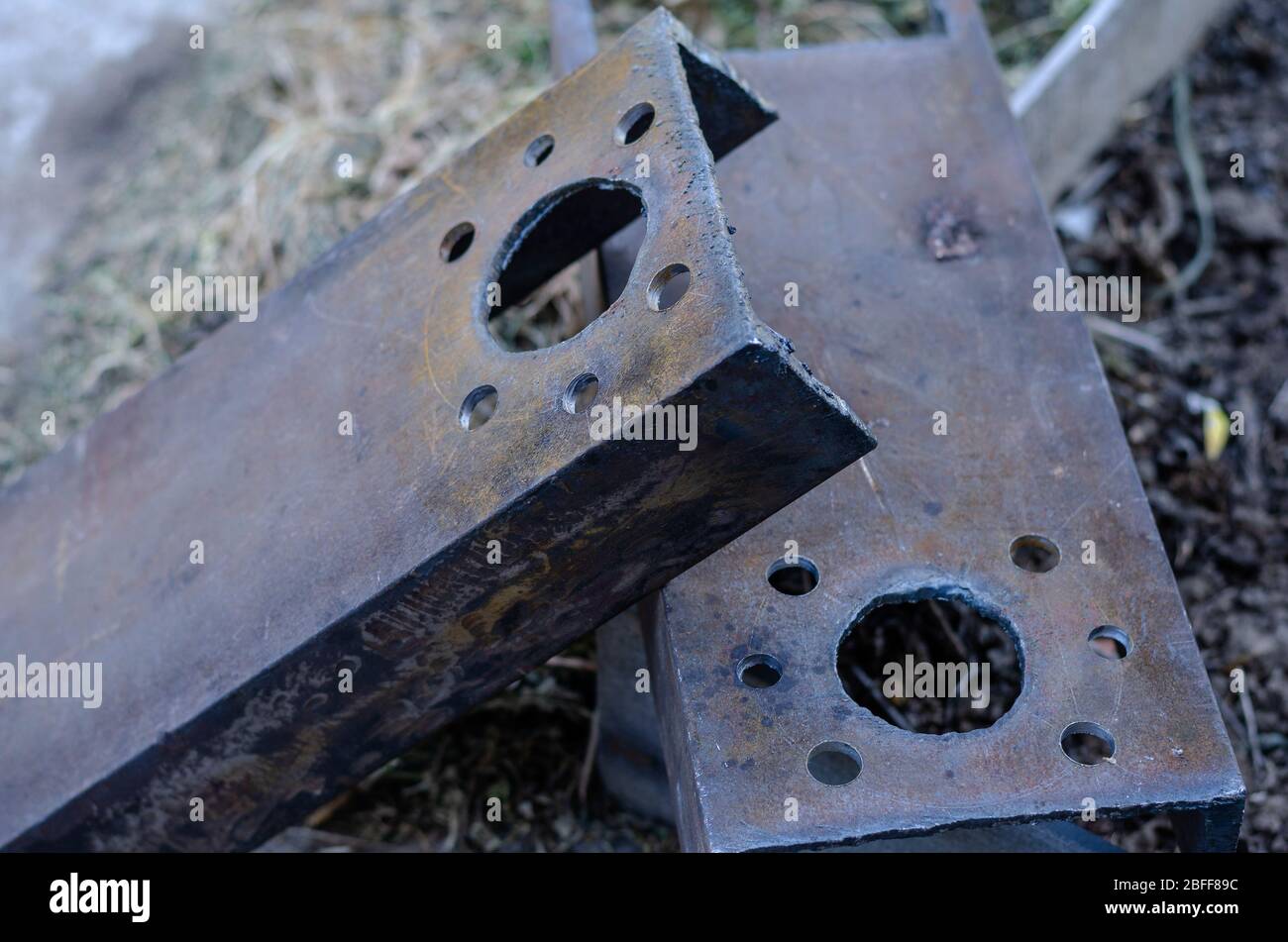 Drilled holes in metal channels. Two massive metal parts with seven