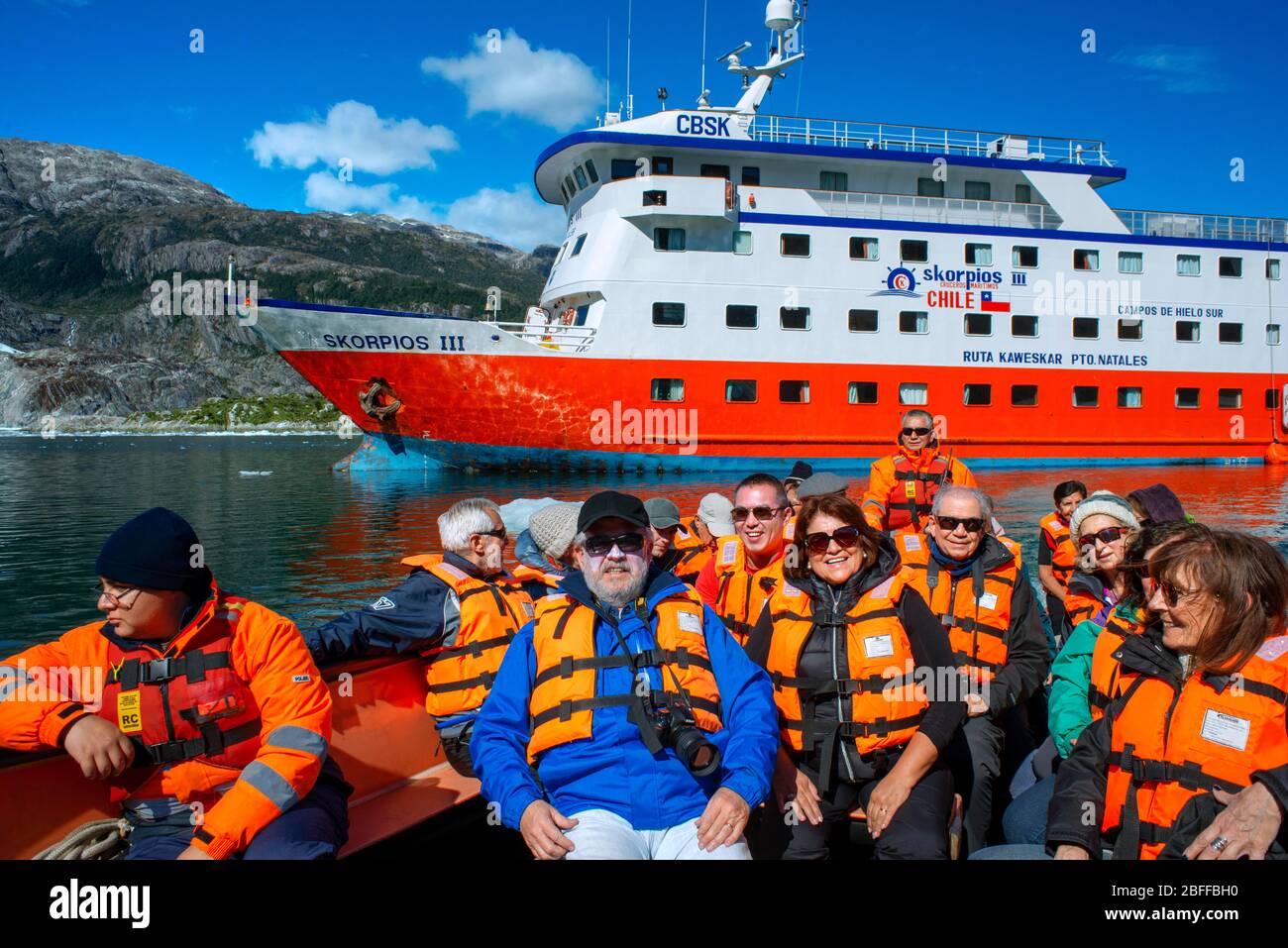 Tourists of Skorpios III cruise at El Brujo Glacier On The Edge Of The Sarmiento Channel in Bernardo O'Higgins National Park in Patagonia Chile fjords Stock Photo