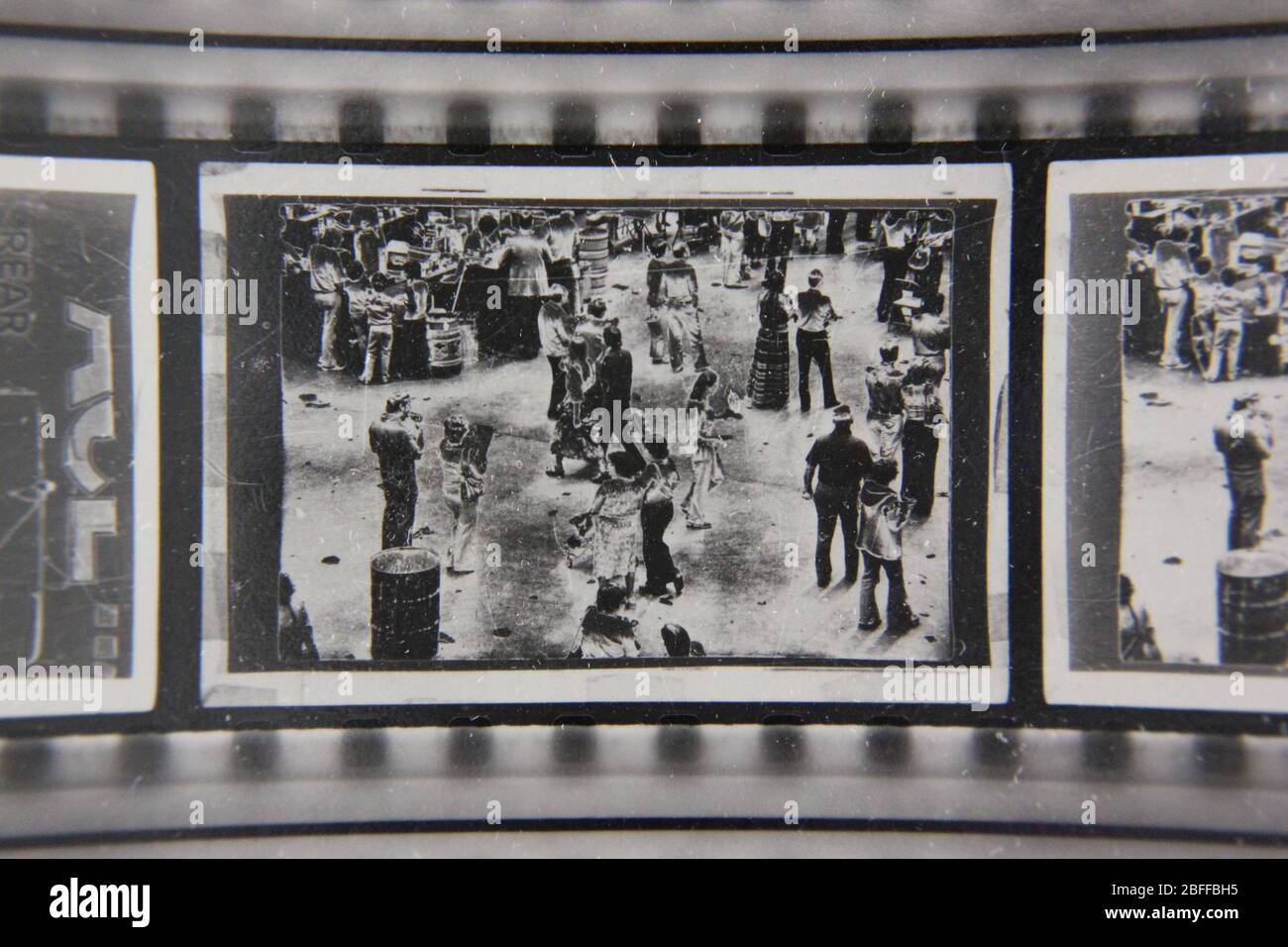 Fine 70s vintage extreme high contrast contact print photography of a gathering crowd of people Stock Photo