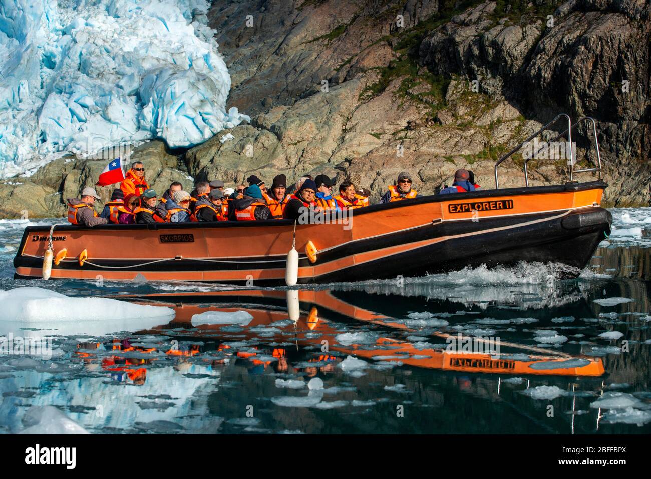 Tourists of Skorpios III cruise at Alsina glacier On The Edge Of The Sarmiento Channel in Bernardo O'Higgins National Park in Patagonia Chile fjords n Stock Photo