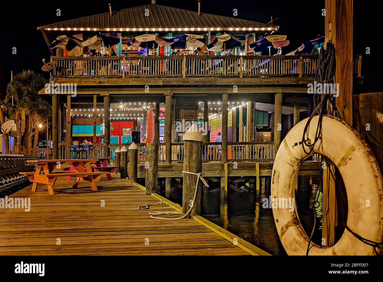 People dine at night at Shaggy’s seafood restaurant, June 27, 2013, in