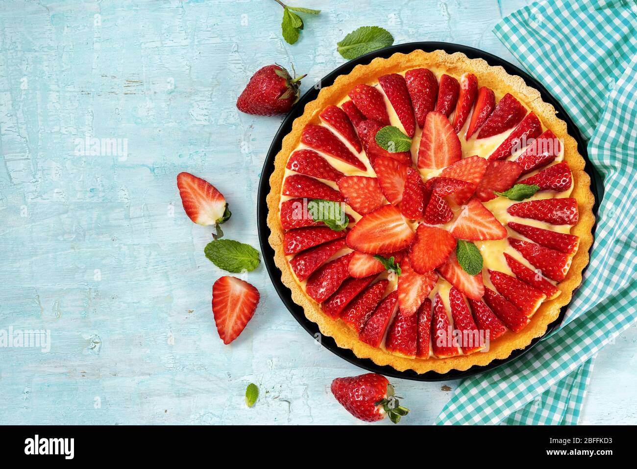 Top view of strawberry cake on light mint background Stock Photo - Alamy